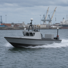 Boat on water with industrial background