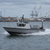 Boat on water with industrial background