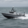 Boat navigating through choppy waters on a cloudy day